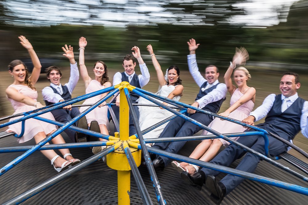 wedding photo of bridal party on merry-go-round in a Christchurch park