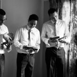 photograph of the groomsmen opening their presents from the groom