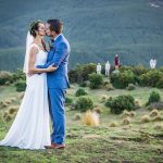 wedding photo of bride and groom kissing at the top of a ridge during a wedding in Lorburn near Rangiora