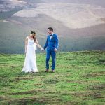 wedding photo of bride and groom taking a walk at the top of a ridge during a wedding in Lorburn near Rangiora