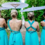 Wedding photography of bridesmaids stating in line with back to the photographer and bride in the distance