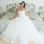 Christchurch photo bride sitting on a bed looking away from the photographer