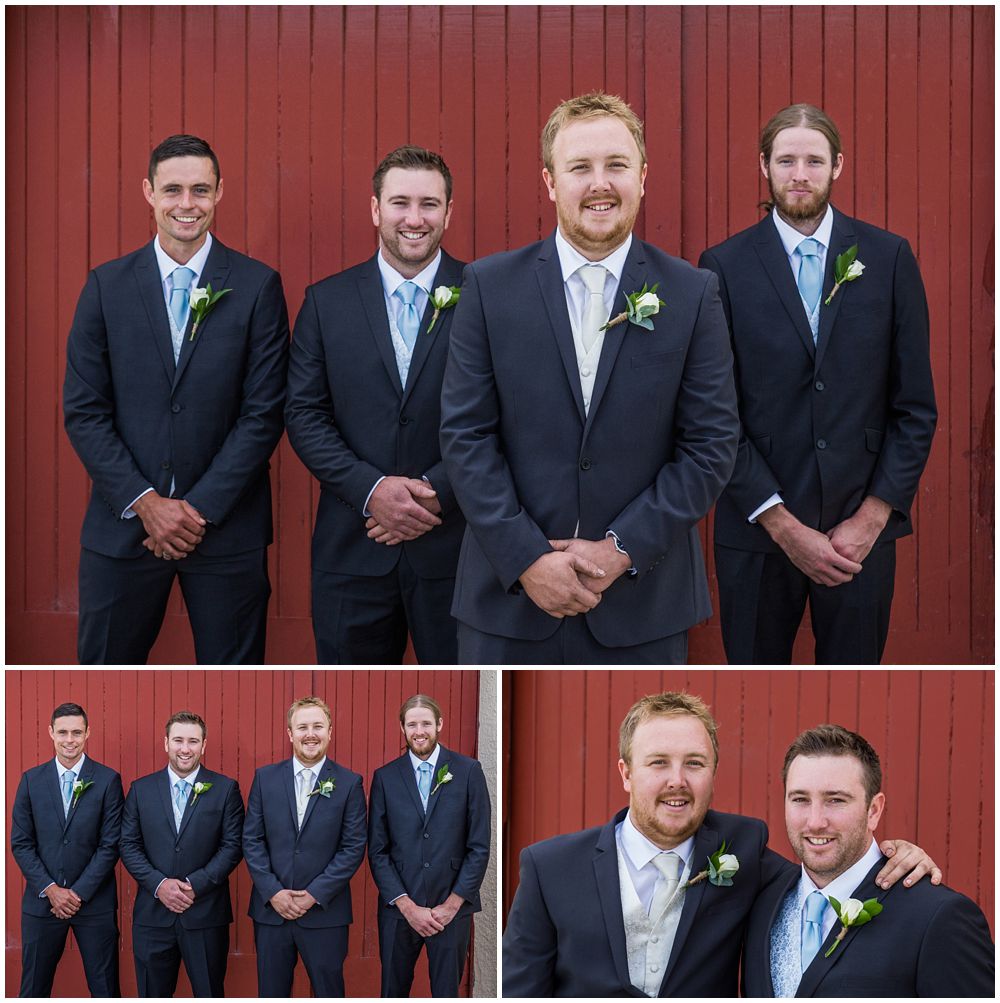 Groom and groomsmen pose for photos in front of red wooden door