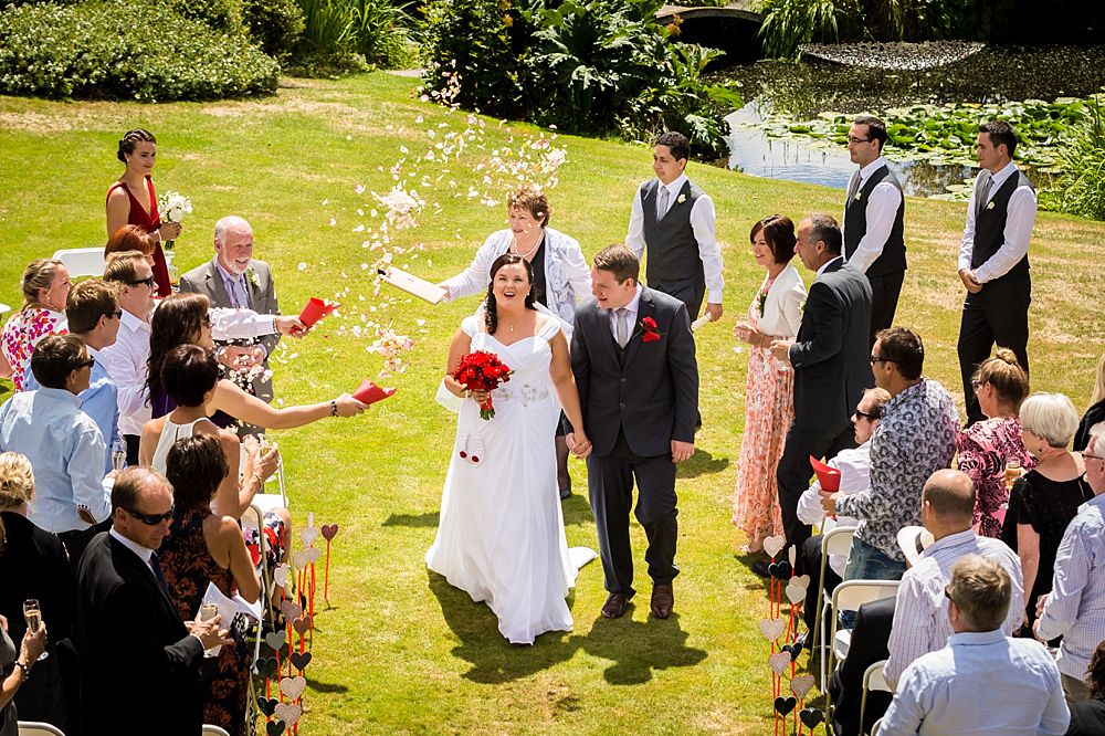 Bride and groom walk out at the end of the ceremony at Flaxmere Garden Wedding Venue 