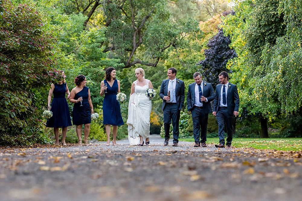 The Gym Art Centre Wedding-Bridal party walking in line on a path in Botanical Gardens-Christchurch