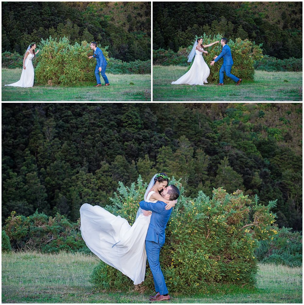 Bride and groom surprise each other from behind the bushes and end up with a big hug