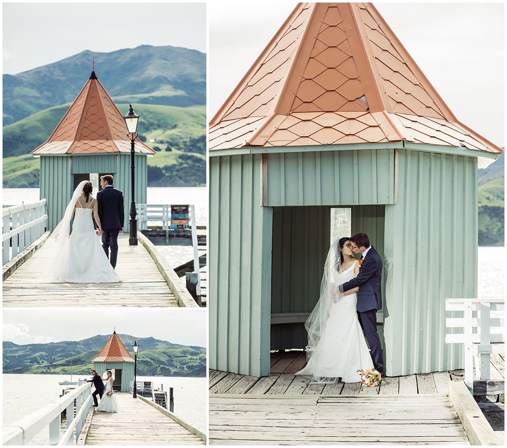 Bride and groom posing in front of a hut on wharf at Akaroa Harbour