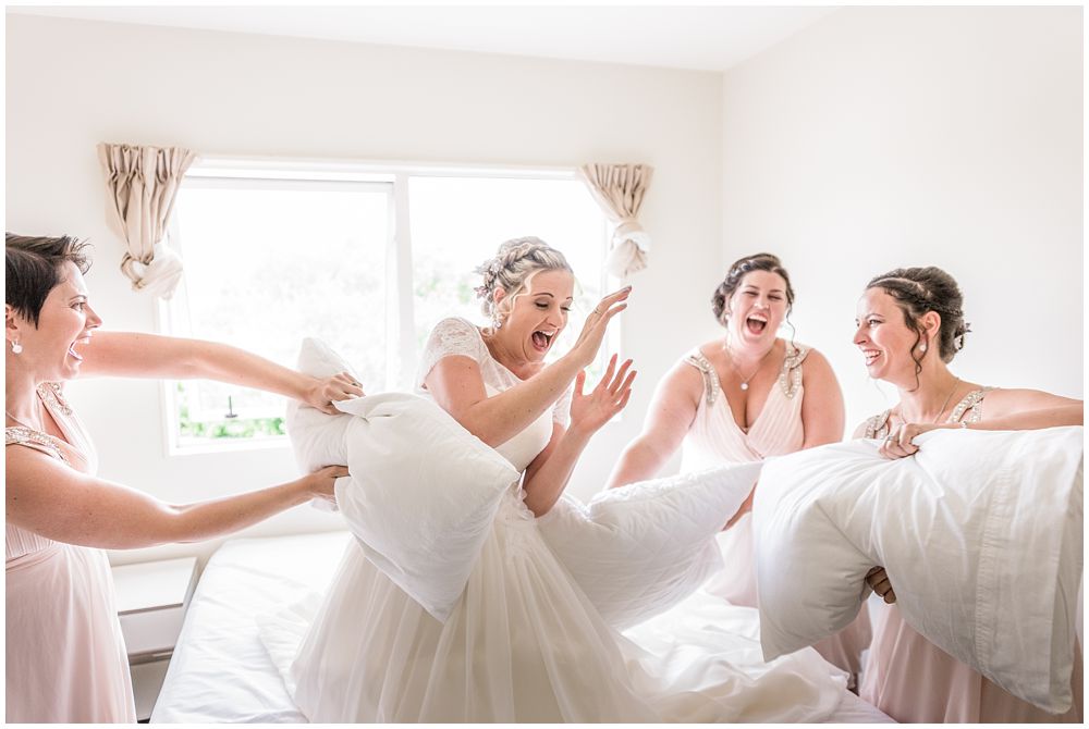 Tannery Wedding-Bridesmaids and bride having a pillow fight 