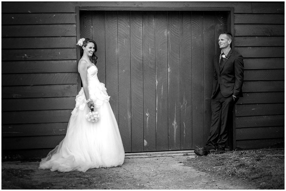 bride-groom standing facing ivy barn at Tipapa Woolshed Barn Wedding Venue