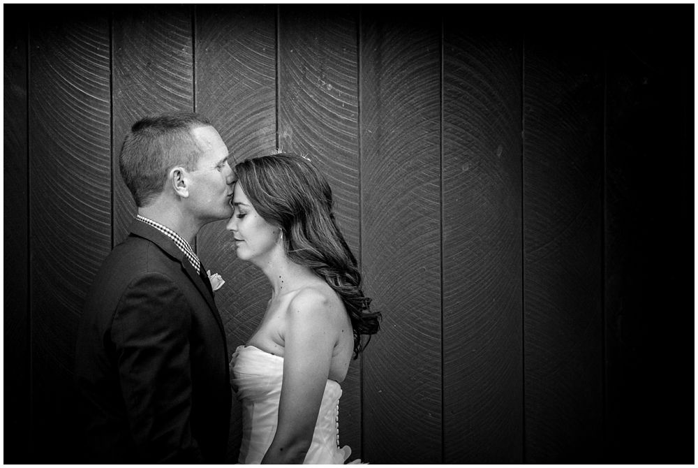 groom kisses bride on forehead at Tipapa Woolshed-Greta Valley