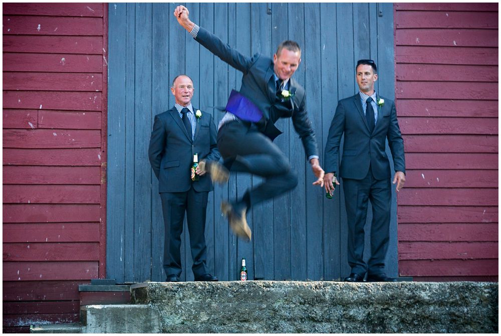 groom jumping from top of stairs at Tipapa Woolshed Barn Wedding Venue