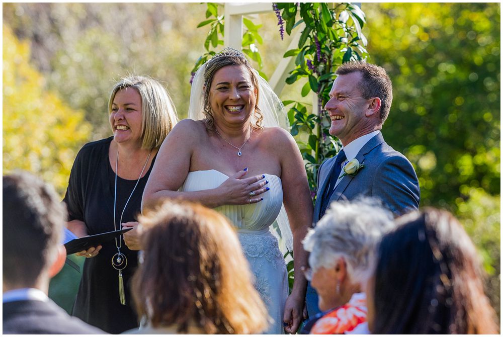 Bride and groom cracking up laughing