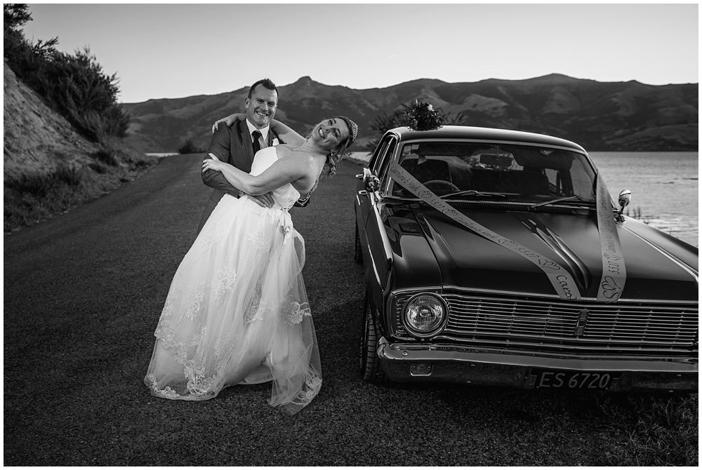 couple dancing next to black car