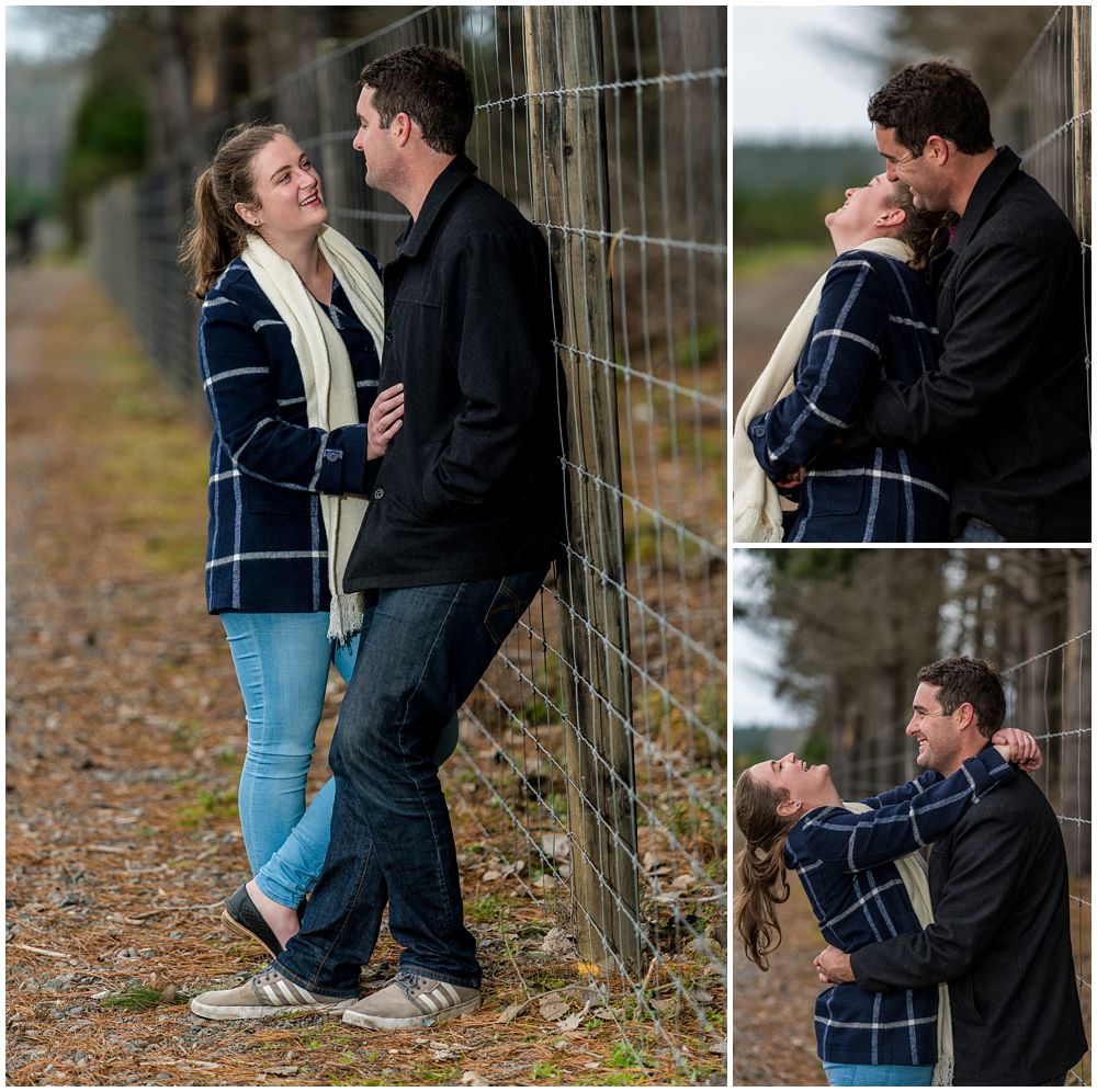 engaged couple standing by the fence