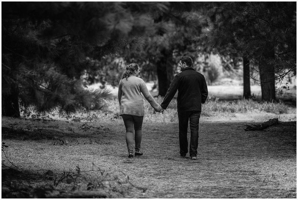 Lovers walking hand in hand in forest