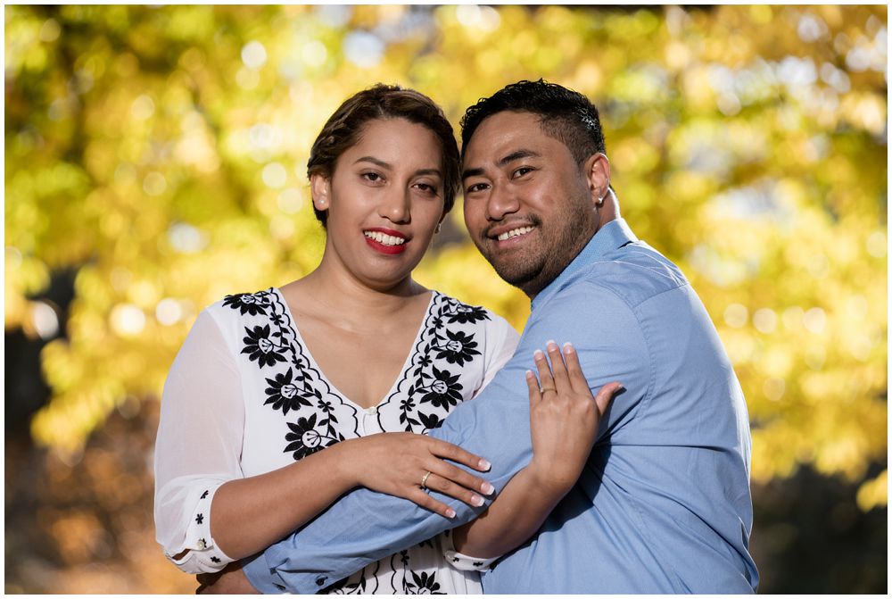 couple hugging under a tree in the park