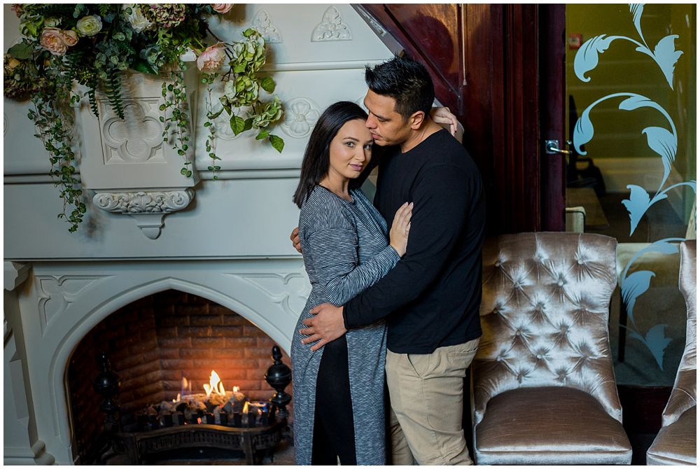 Couple standing by the fire place