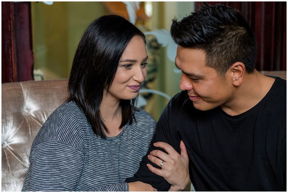 engaged couple closely sitting together