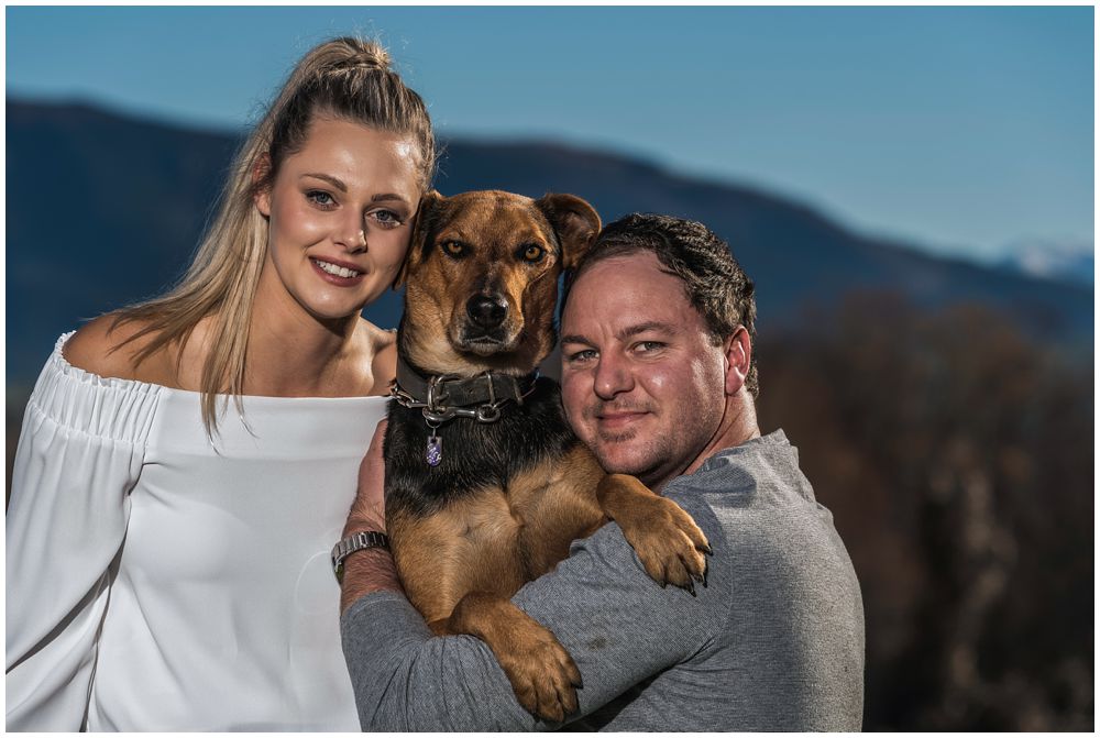 engaged couple with their pet dog