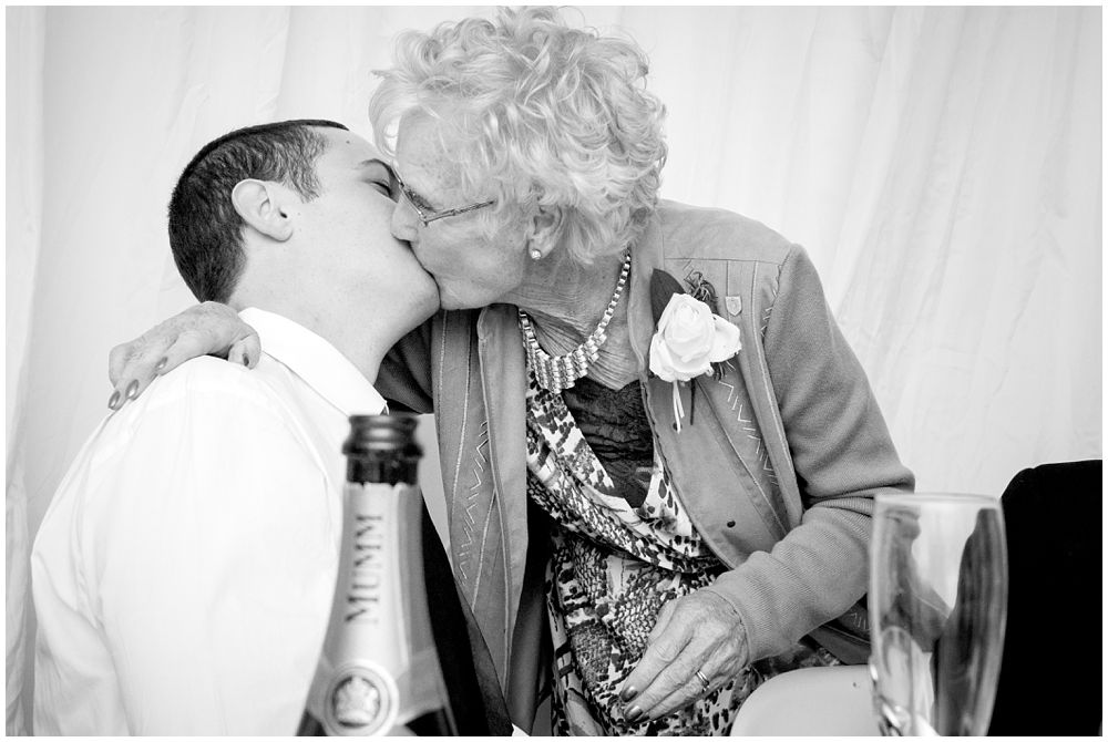 Grandma Kiss planted on the groom during a wedding reception